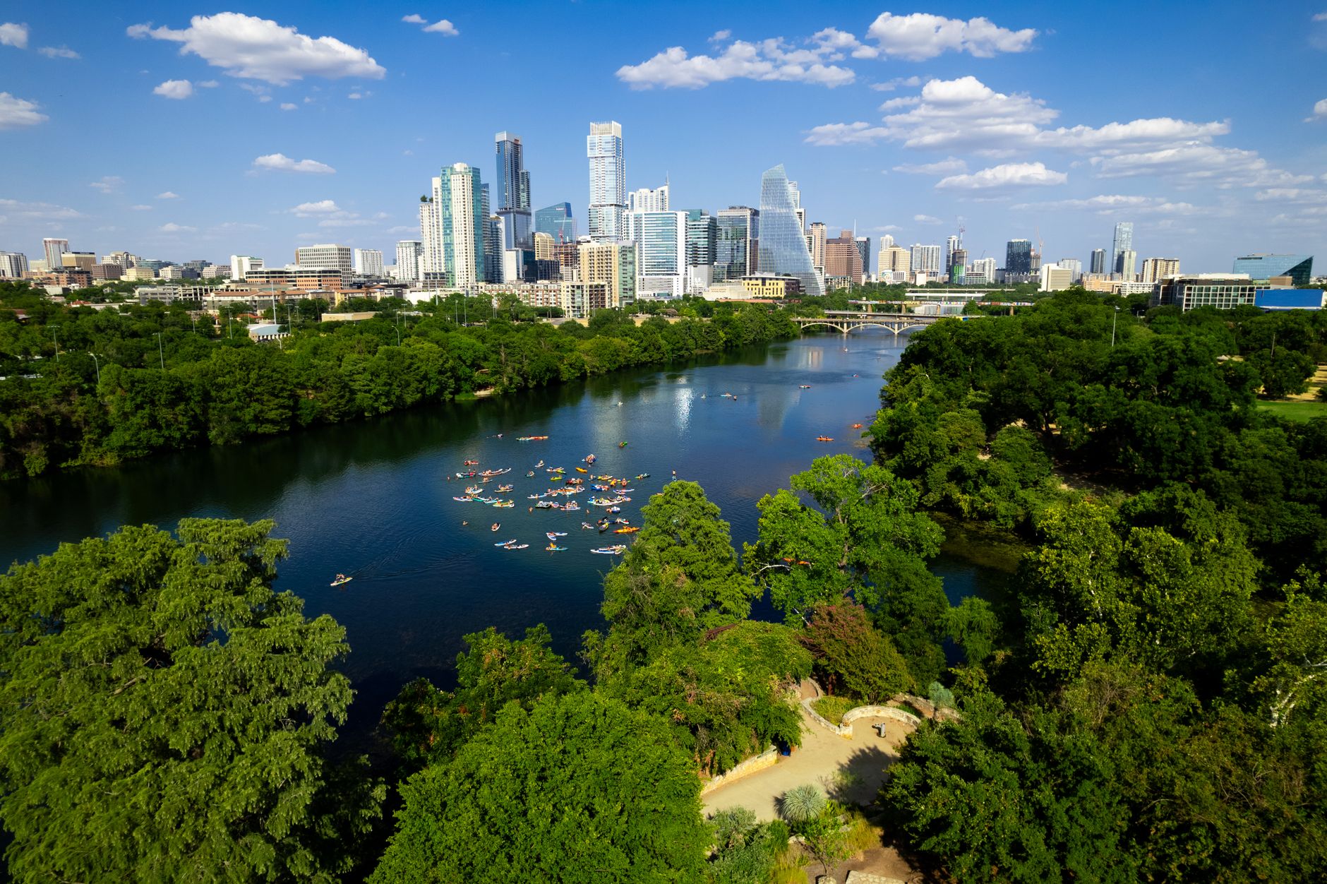 Scenic aerial view of downtown Austin, Texas, featuring the river and lush greenery