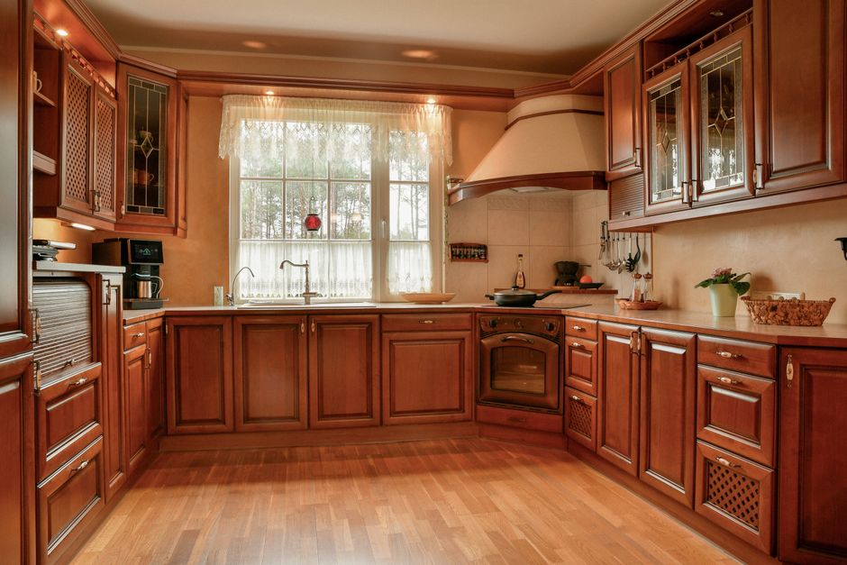Traditional kitchen with warm wooden cabinets and a tiled floor.